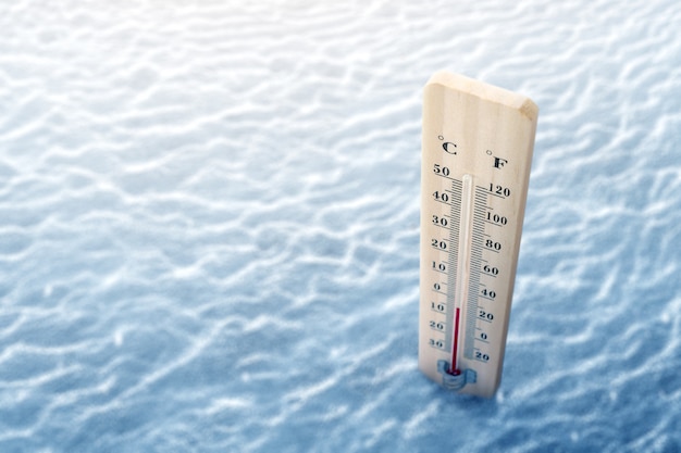 Hölzernes Thermometer mit der niedrigen Temperatur am Winter