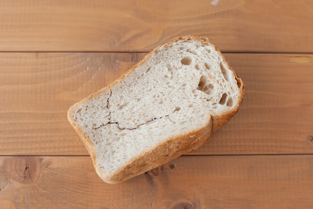 Una hogaza de pan seco sobre una mesa de madera. comida vieja