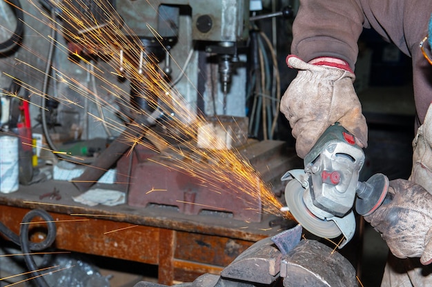 Foto hoja de metal de corte de molienda de trabajador con máquina amoladora