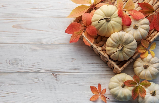 Hojas de otoño y calabazas sobre fondo de madera vieja