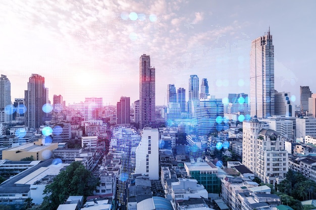 Holograma brilhante do mapa do planeta Terra na paisagem urbana panorâmica aérea de Bangkok ao pôr do sol Ásia O conceito de negócios internacionais Multi Exposição