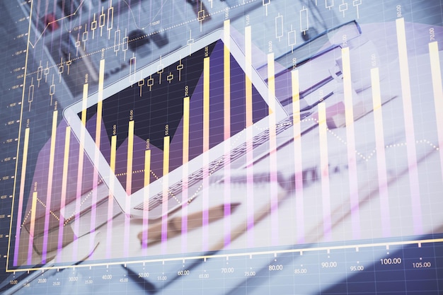 Holograma de gráfico de divisas en la mesa con fondo informático Múltiple exposición Concepto de mercados financieros