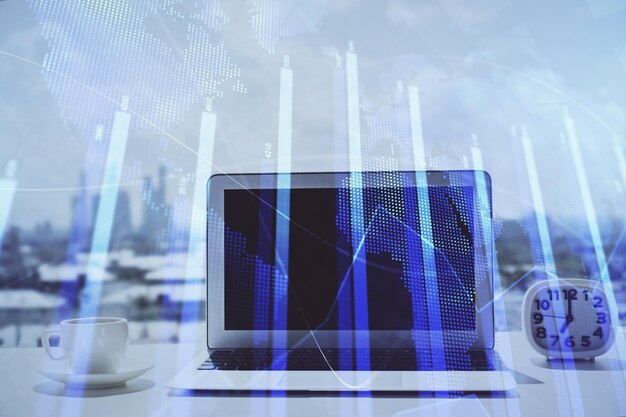 Holograma gráfico de forex en la mesa con fondo de computadora Concepto de exposición múltiple de los mercados financieros