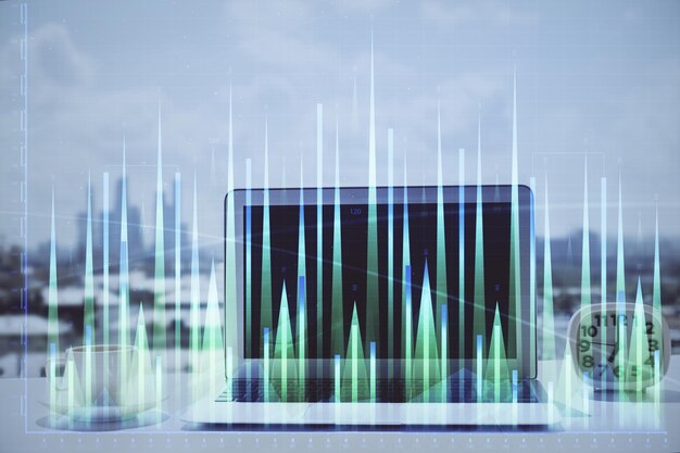 Holograma gráfico de Forex en la mesa con fondo de computadora Concepto de exposición múltiple de los mercados financieros