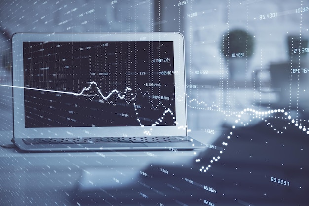 Holograma de gráfico de mercado de divisas y computadora personal en el fondo Exposición múltiple Concepto de inversión