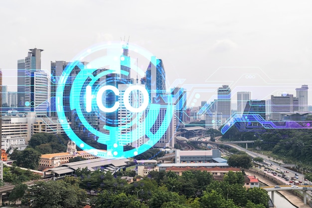 Holograma del icono ICO sobre la vista panorámica de la ciudad de Kuala Lumpur KL es el centro de los proyectos blockchain en Malasia Asia El concepto de oferta inicial de monedas Doble exposición