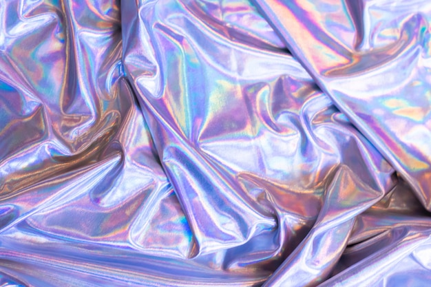 Holographischer schillernder Meerjungfrauenfolienbeschaffenheitshintergrund. Futuristische neonfarbene trendige Silberfarben