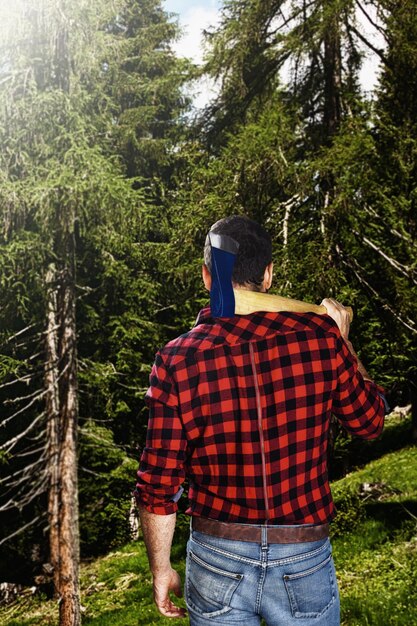 Holzfäller von hinten zu Fuß in Richtung Wald