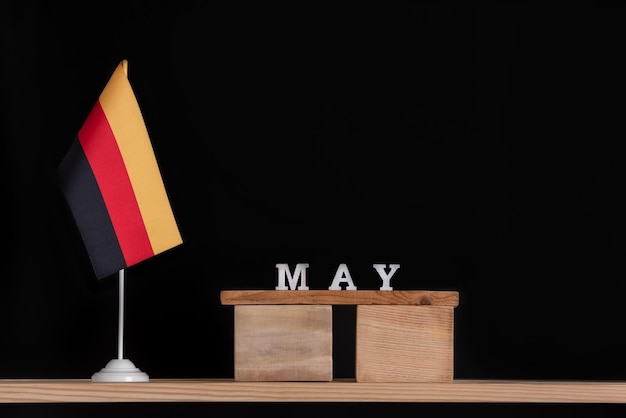 Holzkalender Mai mit deutscher Flagge auf schwarzem Hintergrund Termine in Deutschland im Mai