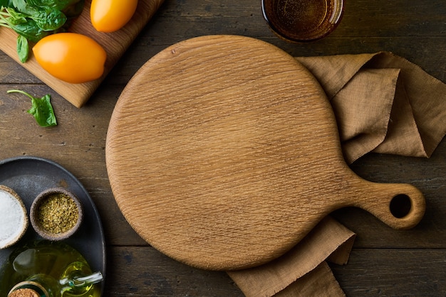 Holzschneidebrett auf dunklem Hintergrund Kochen Vorbereitung Gemüse und Gewürze