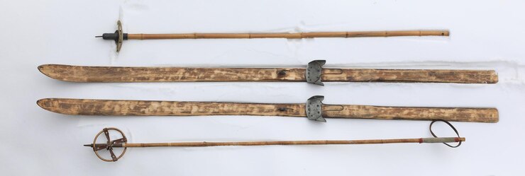 Holzskier und Bambus-Skipfähle auf dem Schnee