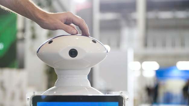 Hombre acariciando robot como mascota medios de comunicación de cerca de la mano humana acariciando la cabeza del robot perro nuevo futurista