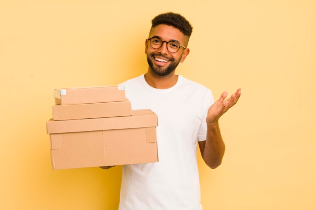 Hombre afro negro que se siente feliz sorprendido al darse cuenta de una solución o concepto de cajas de envío de ideas