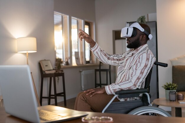 Hombre afroamericano con discapacidad preparando presentación virtual