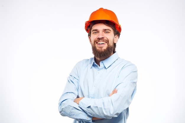 Hombre alegre naranja casco trabajo industria estilo de vida profesional fondo claro