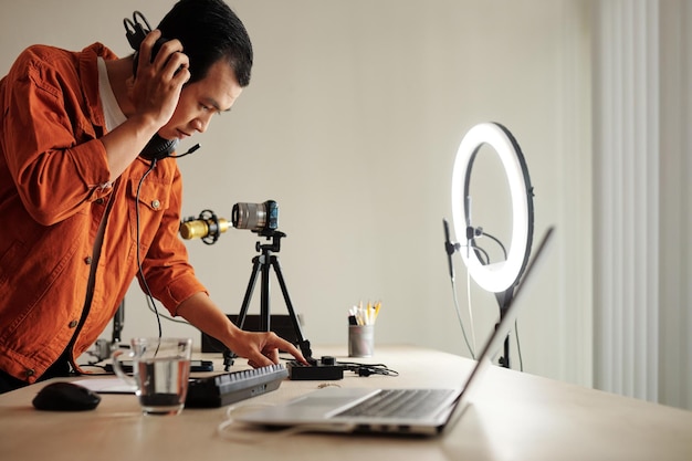 Hombre asiático ajustando la configuración de sonido