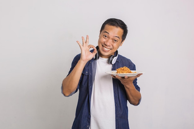 Hombre asiático comiendo fideos instantáneos y se sorprende de lo delicioso que es