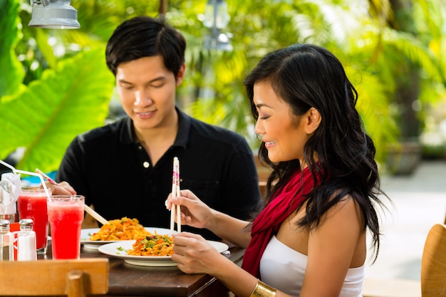 Hombre asiático y mujer en restaurante