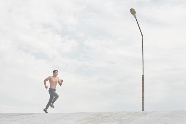 Hombre atleta asiático trotar en la mañana al aire libre