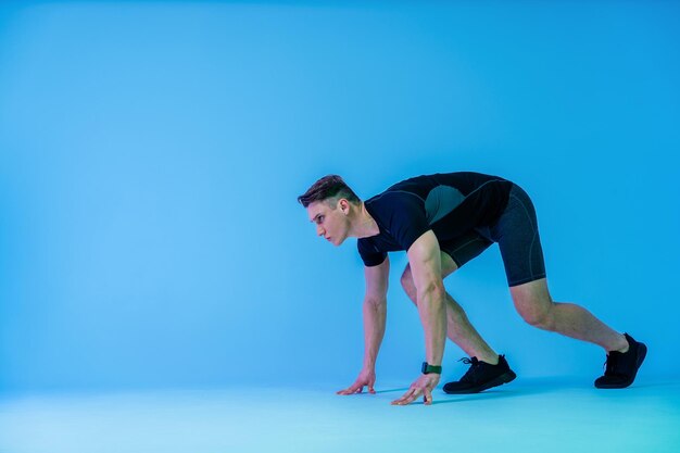 Hombre atlético con cuerpo musculoso en forma entrenando en el estudio