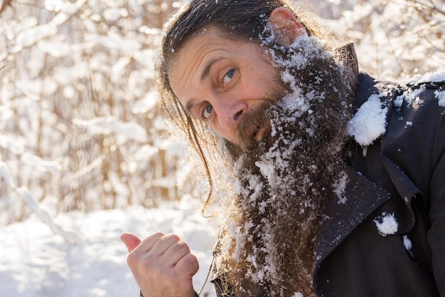 Un hombre con barba en la nieve, con cara de enojo.