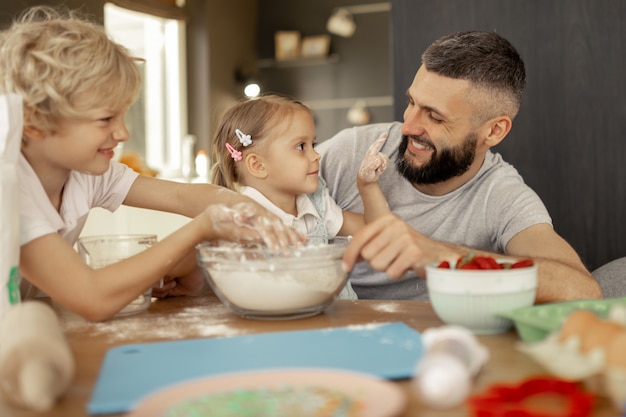 Hombre barbudo encantado sonriendo a su hija