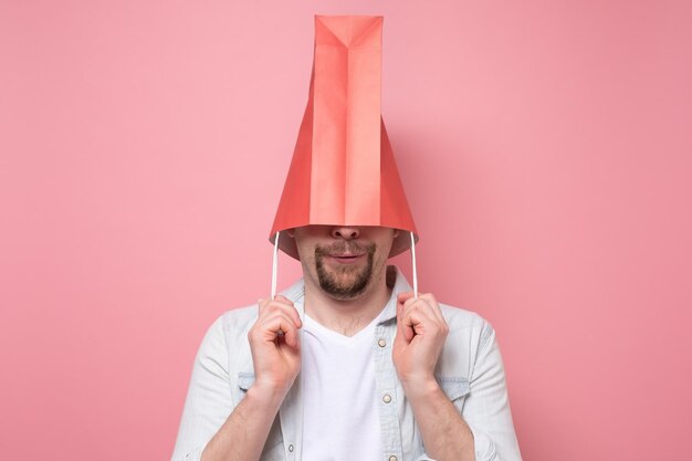 Hombre con bolsa de papel en la cabeza para esconderse del mundo