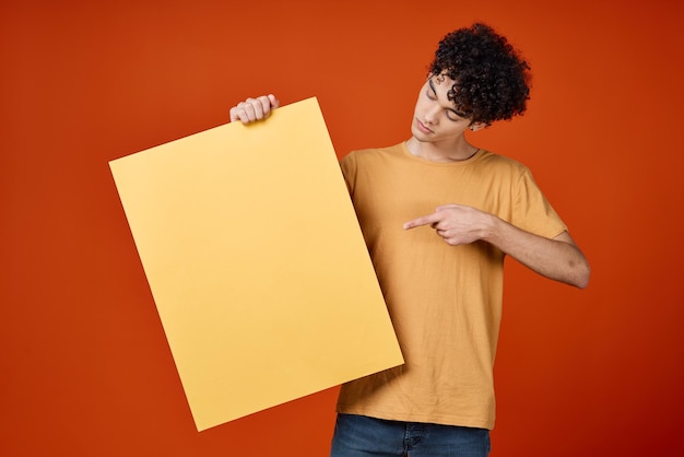 Hombre con el cabello rizado sosteniendo una isla en sus manos publicidad foto de alta calidad