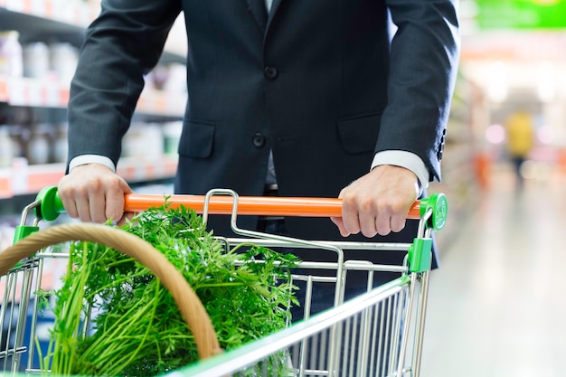 hombre con carrito de compras en supermercado