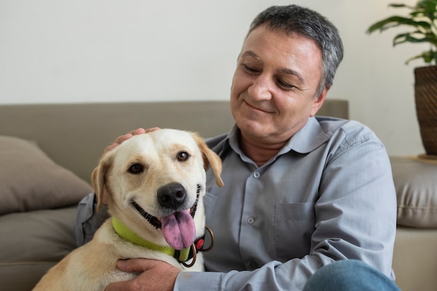 Foto hombre en casa con su compañero de perro