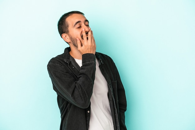 Hombre caucásico joven aislado sobre fondo azul riendo emoción feliz, despreocupada, natural.