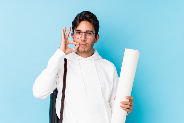 Hombre caucásico joven que estudia la arquitectura aislada con los dedos en los labios que guardan un secreto.