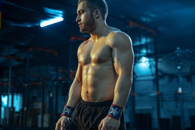 Hombre caucásico practicando en levantamiento de pesas en el gimnasio modelo deportivo masculino caucásico posando