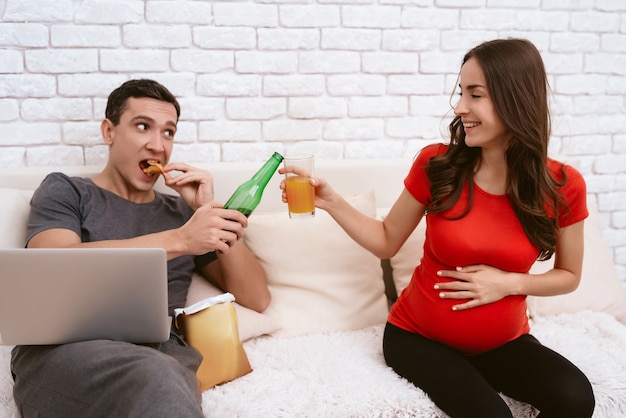 Foto un hombre con cerveza mientras una niña con jugo tintinean vasos.