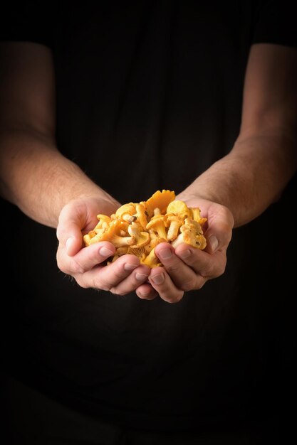 Foto hombre con chanterelles en la mano estilo rústico