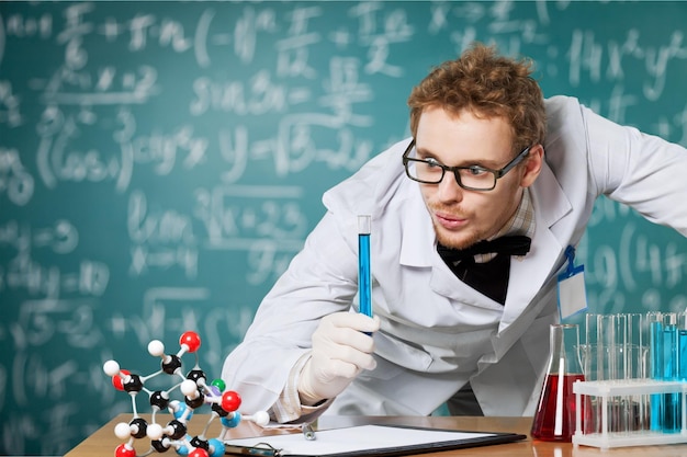 Hombre científico con líquido de color en su laboratorio