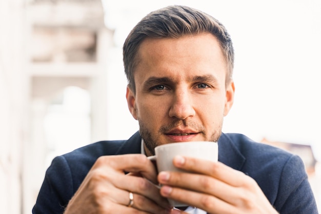 Hombre como café Hombre guapo con taza de café en la cafetería Estilo de vida del hombre por la mañana