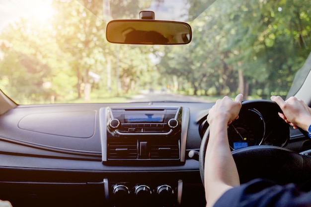 Hombre conduciendo coche desde la vista trasera en la carretera