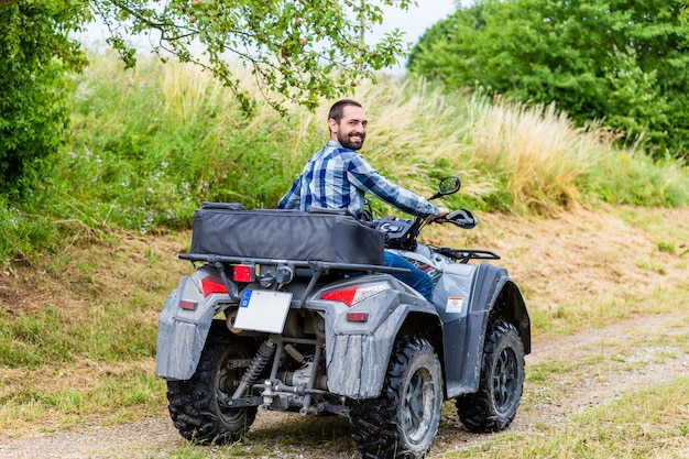 Hombre conduciendo fuera de carretera con quad o ATV