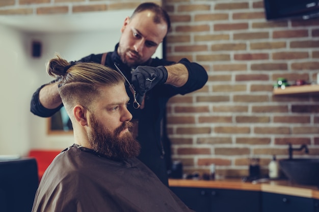 Hombre corte de pelo de moda en peluquería