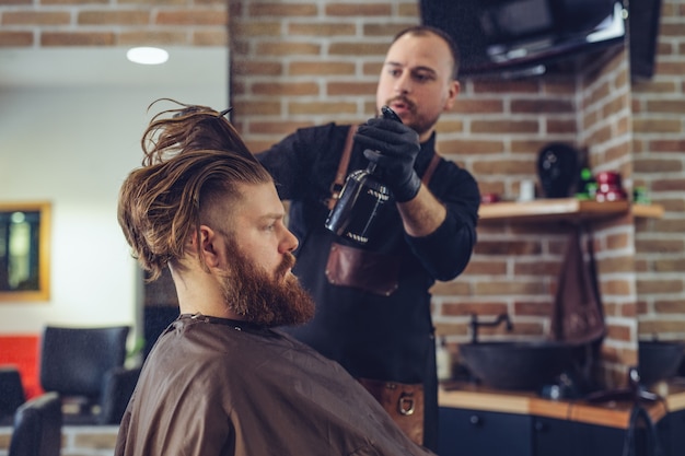 Hombre corte de pelo de moda en peluquería