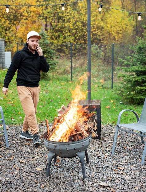 Foto un hombre enciende una barbacoa en la naturaleza