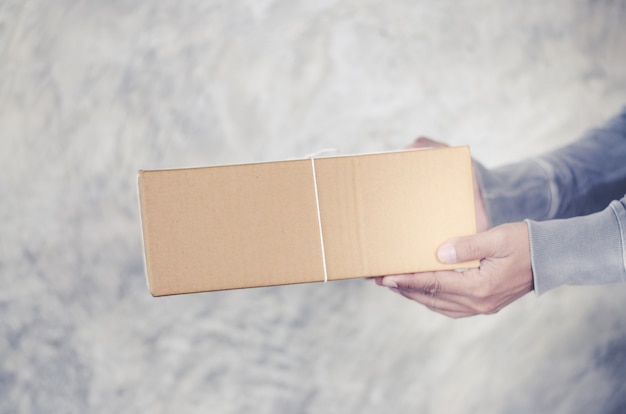 hombre de entrega llevando una caja de paquete