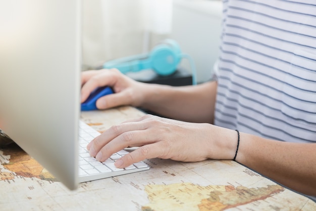 Hombre escribiendo y usando una computadora de escritorio en su casa