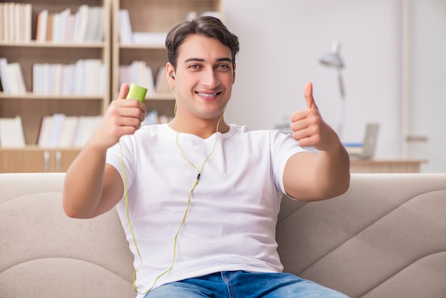 Hombre escuchando música sentado en el sofá