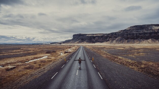 Hombre explorando hermoso destino con su longboard