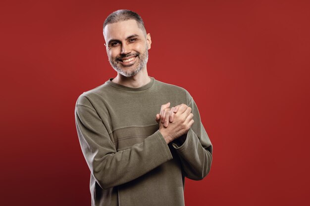 hombre feliz sonriendo con las manos juntas