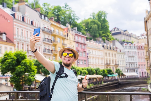 Foto hombre fotografiando mientras usa un teléfono inteligente