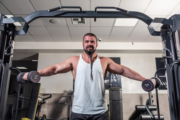 El hombre fuerte está entrenando en el gimnasio.