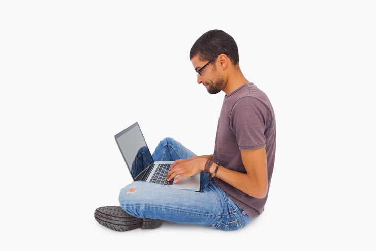 Foto hombre con gafas sentado en el piso usando la computadora portátil